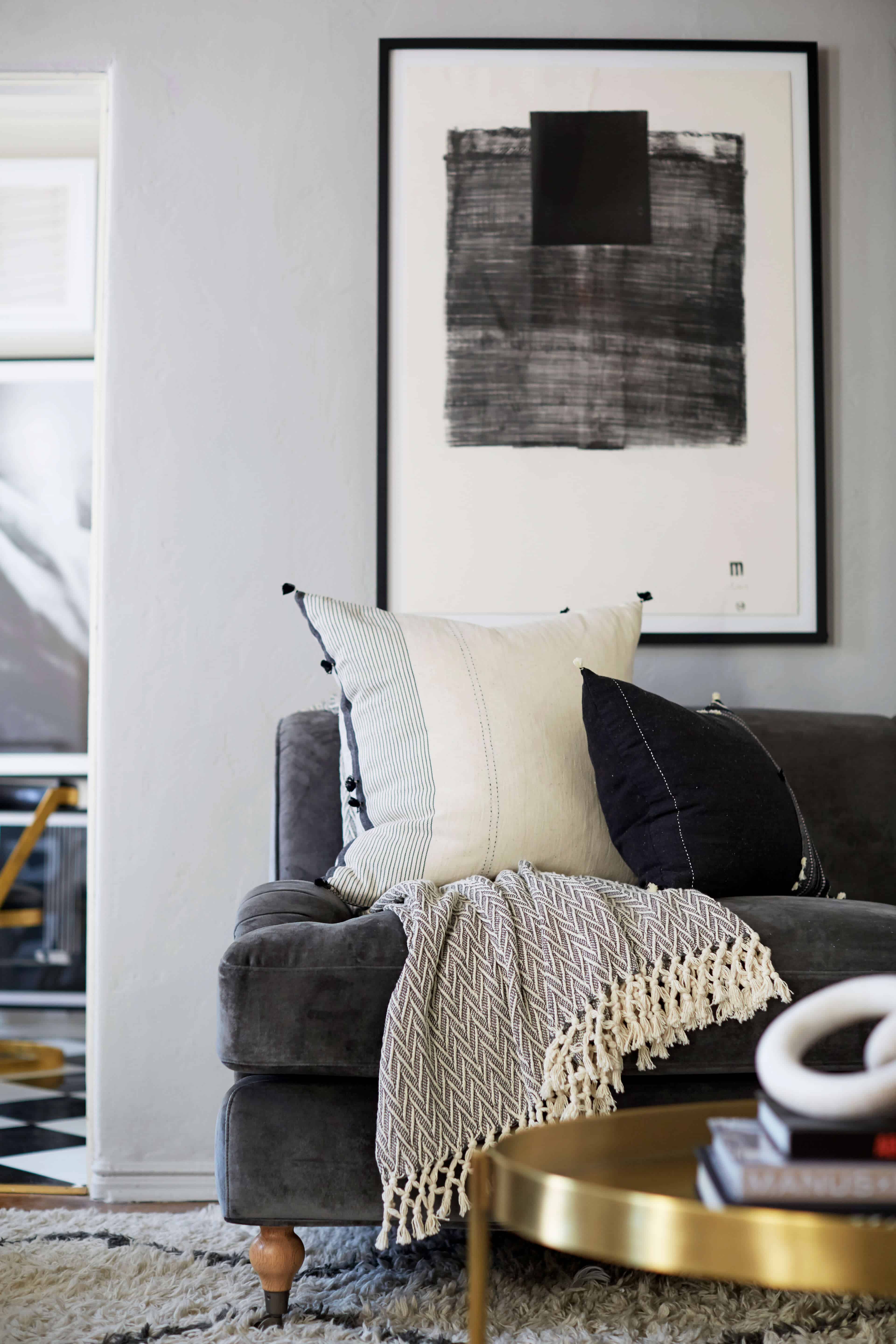 brady-tolbert-design_emily-henderson_living-room_eclectic_pavillion-grey_farrow-and-ball_brass-coffee-table_english-roll-arm_albini_masculine_traditional_west-elm_souk_flokati_leather_17