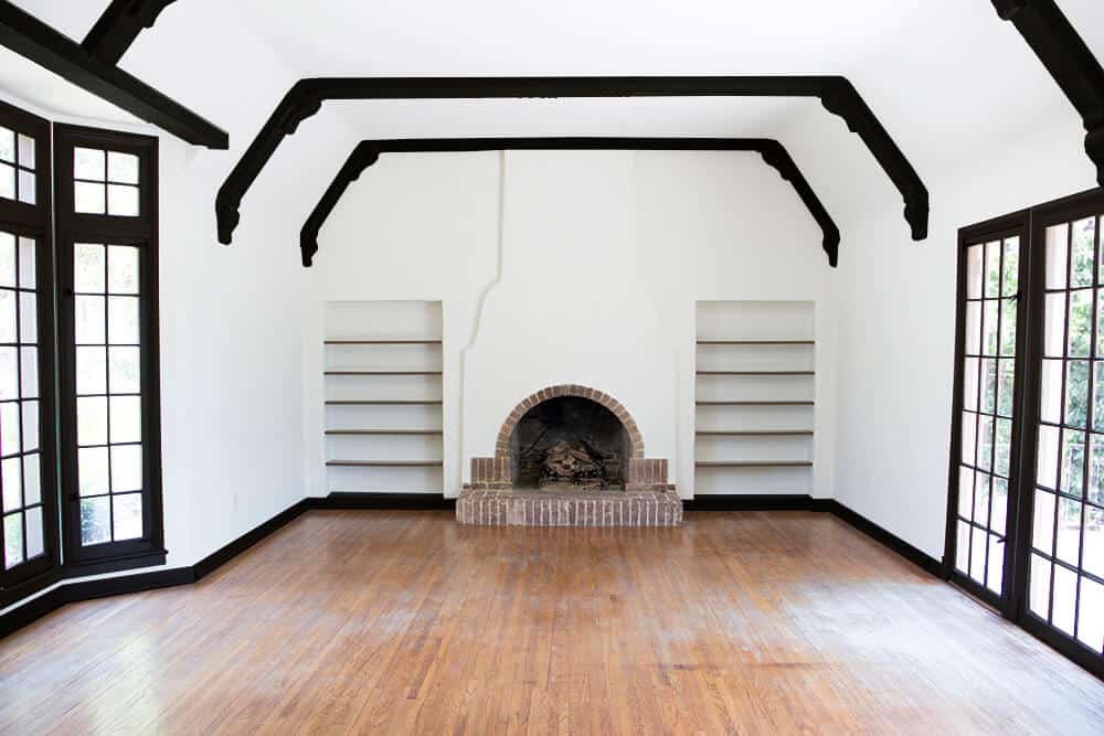 all-black-living-room-emily-henderson_house_living-room_painting_trimwork_white-walls-black-baseboards-black-trim-and-black-beams