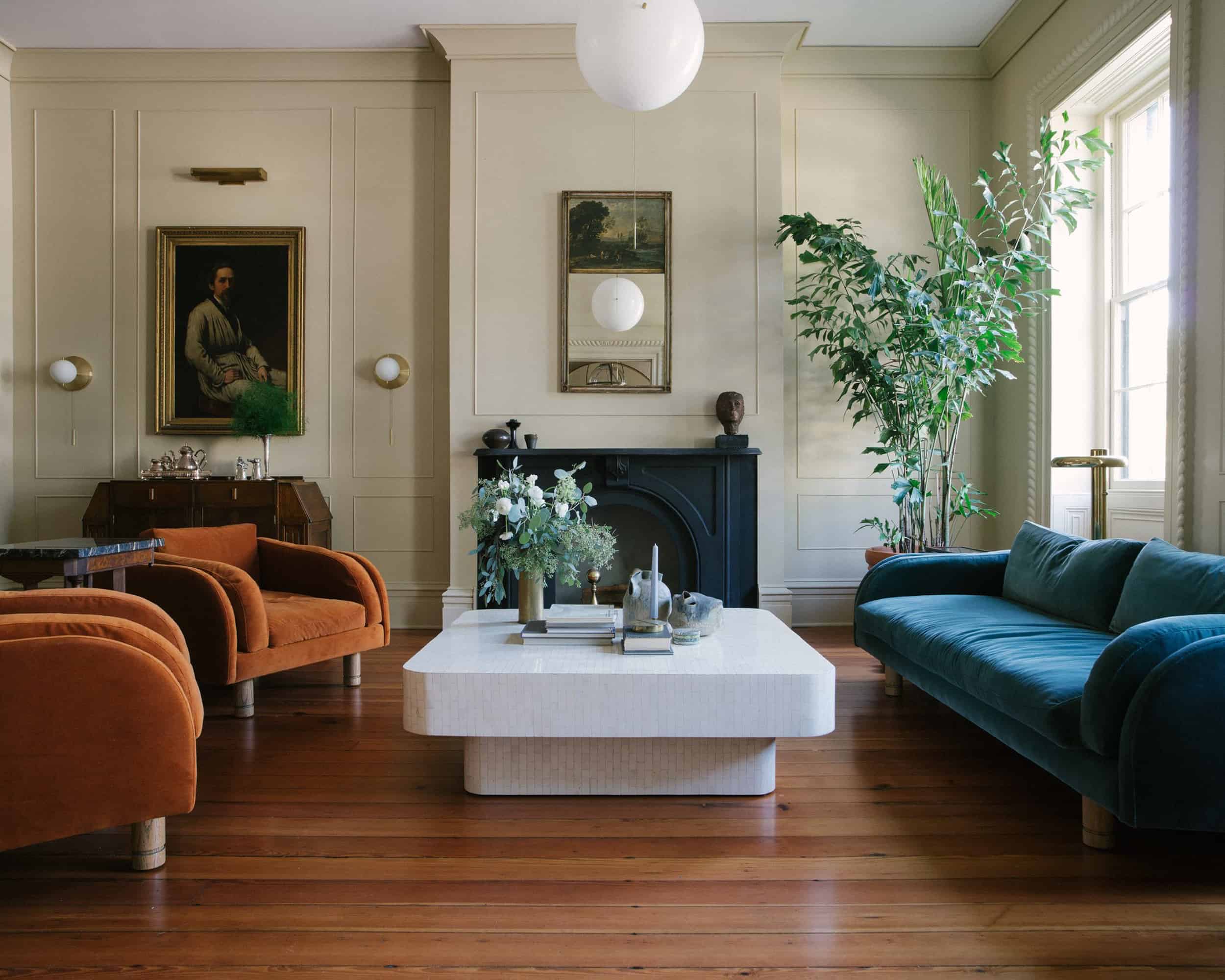 Modern Victorian orange velvet chairs blue sofa white coffee table