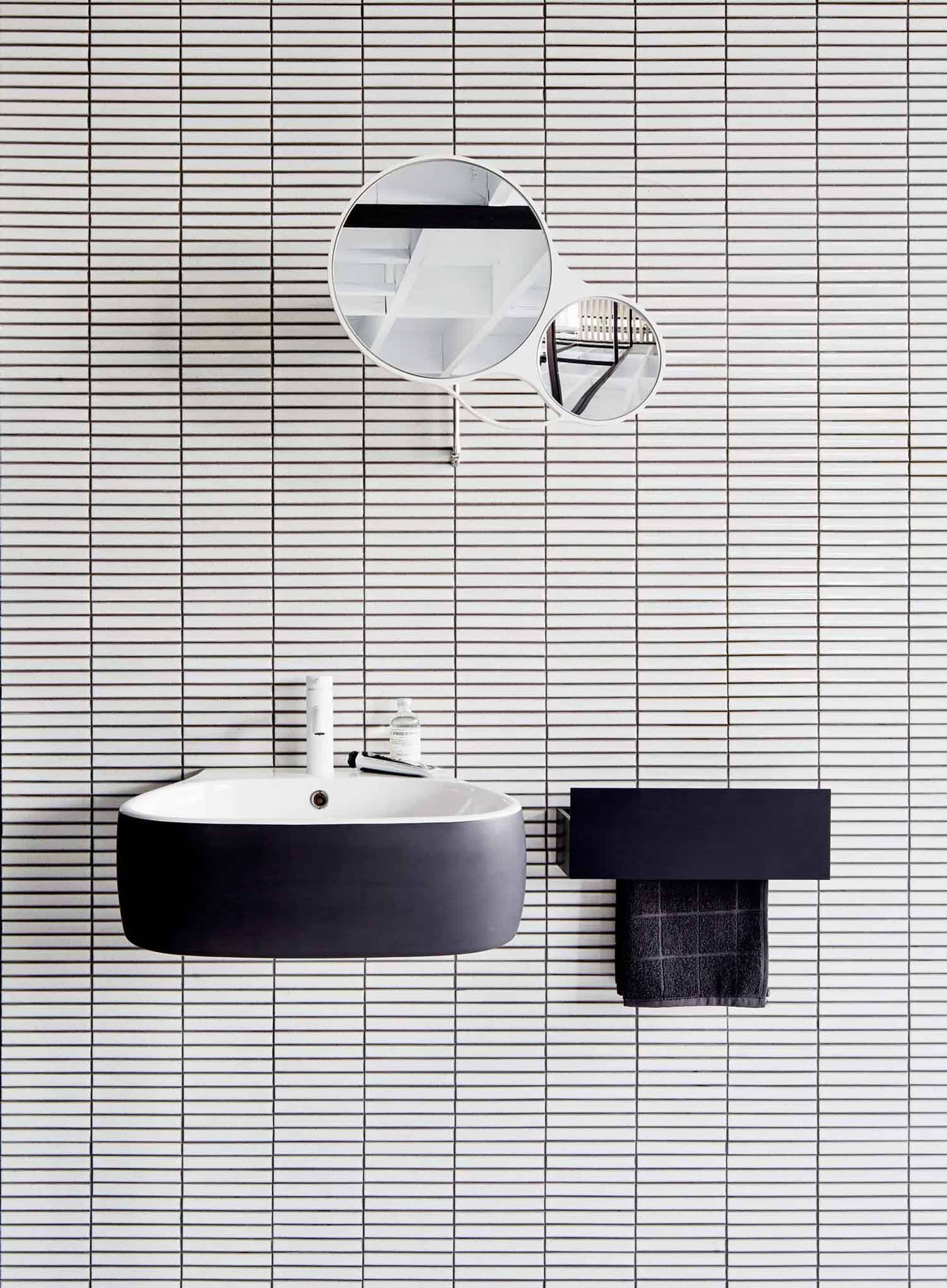 black and white bathroom grid tile black floating sink 