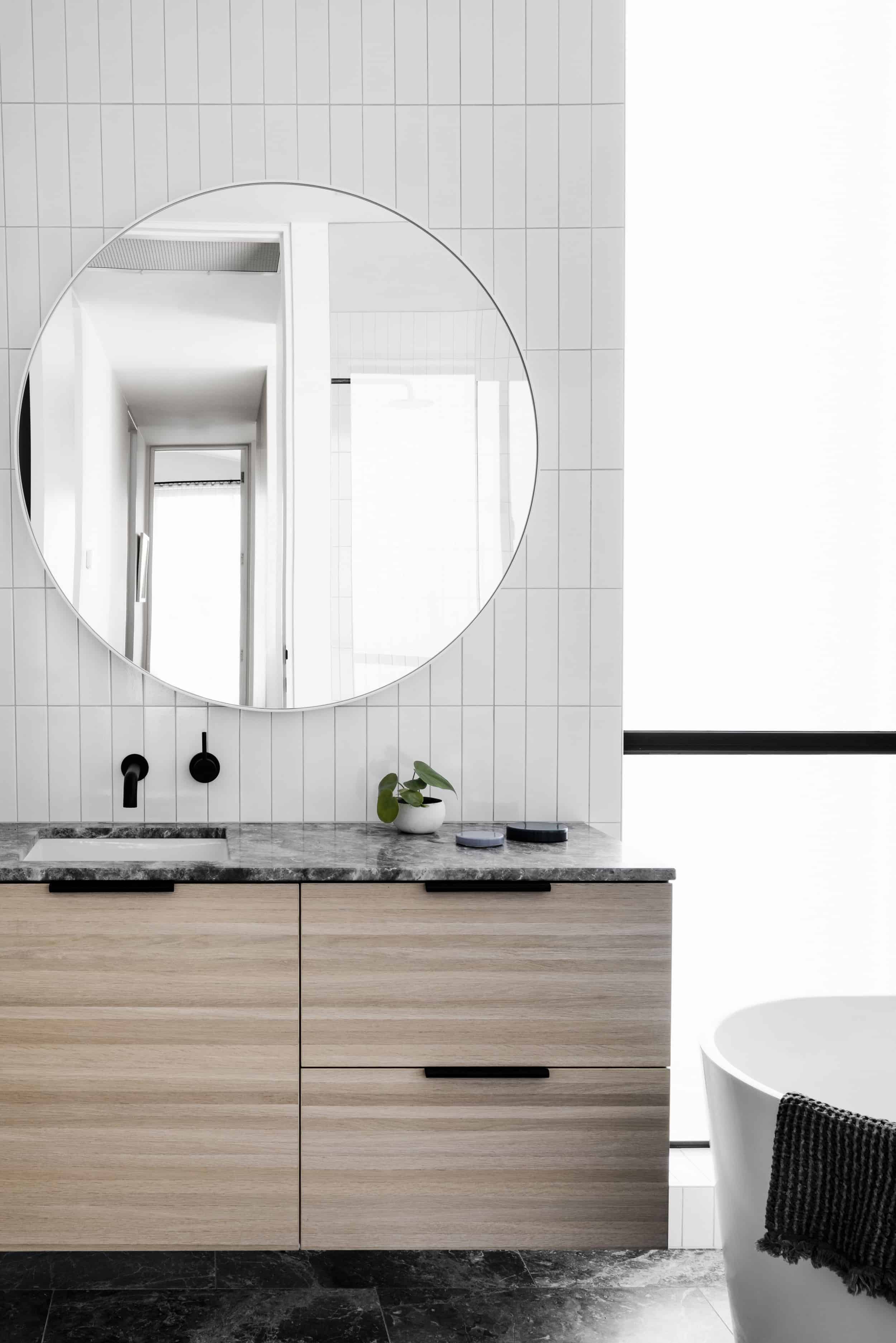 modern bathroom large round mirror under mount sink