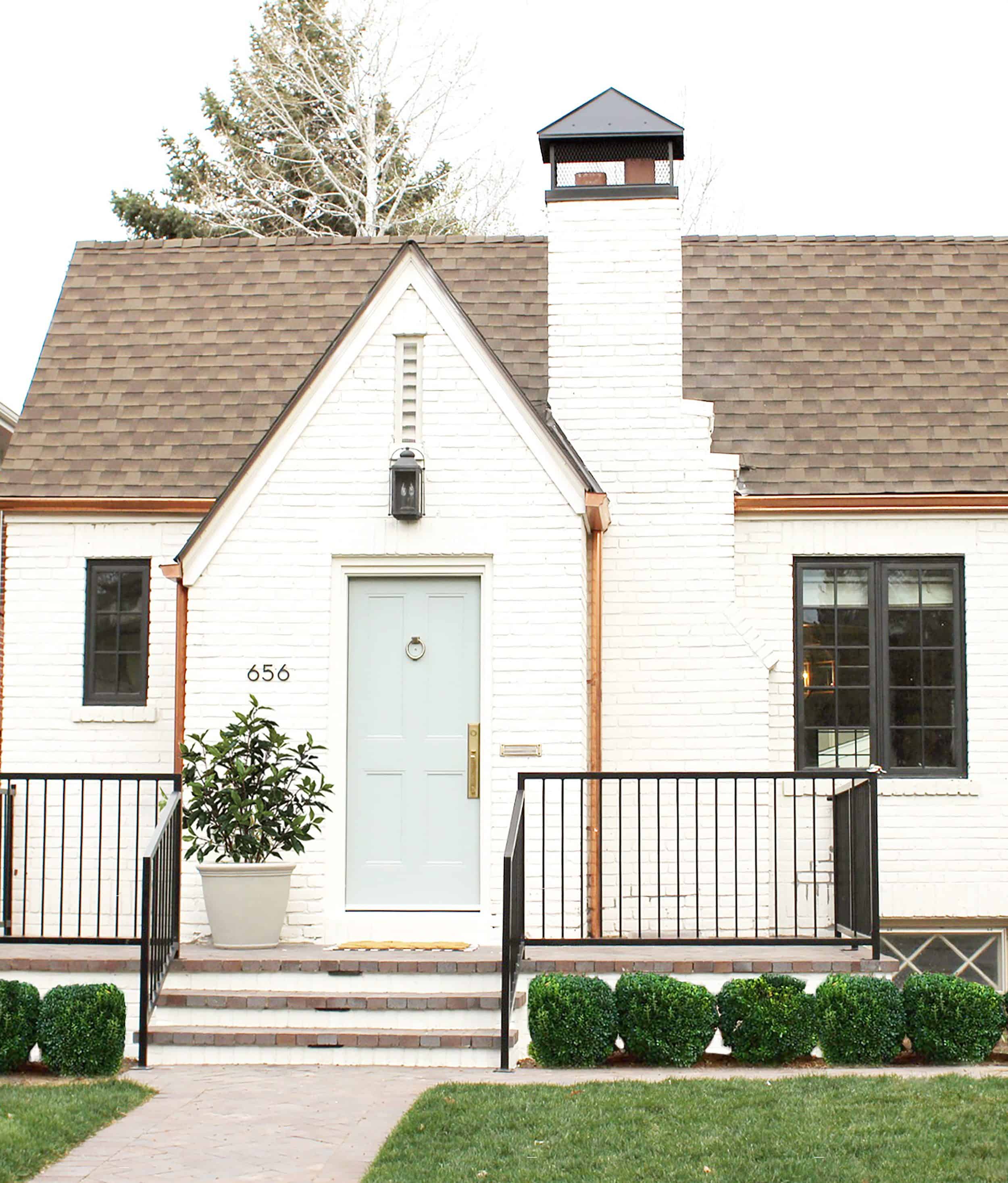White Brick Tudor With Dusty Blue Door