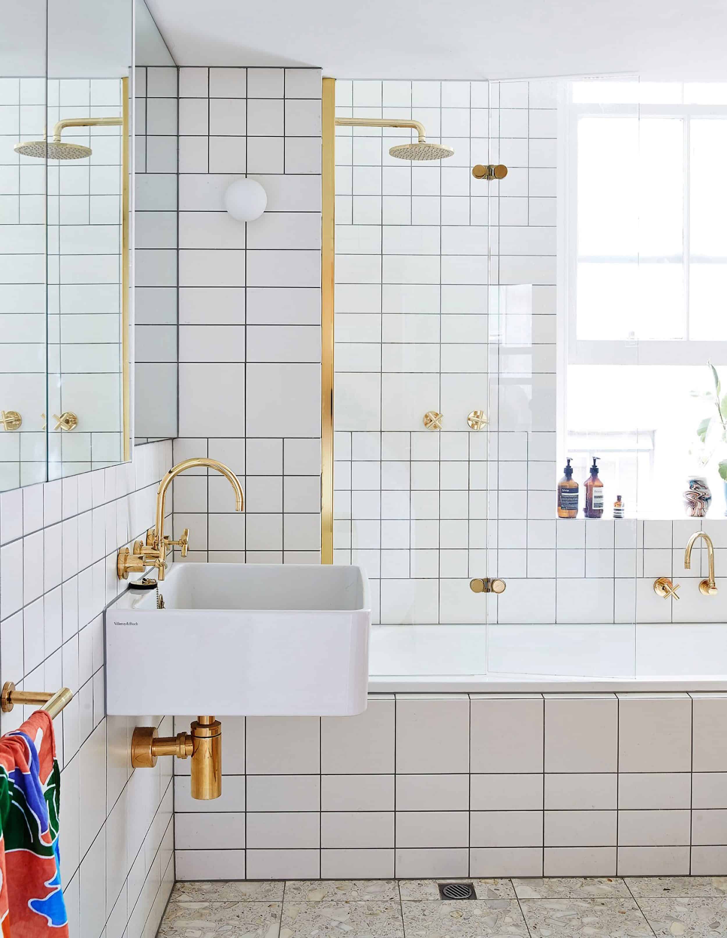 Bathroom With White Tile & Brass Faucet