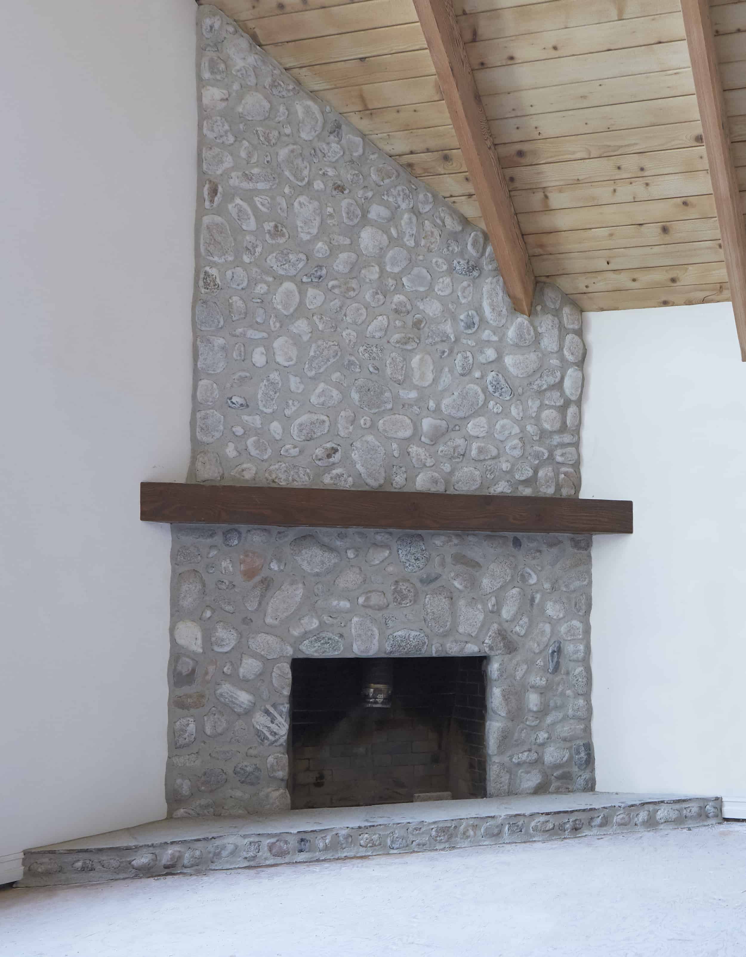 Finished German Schmear River Rock Fireplace