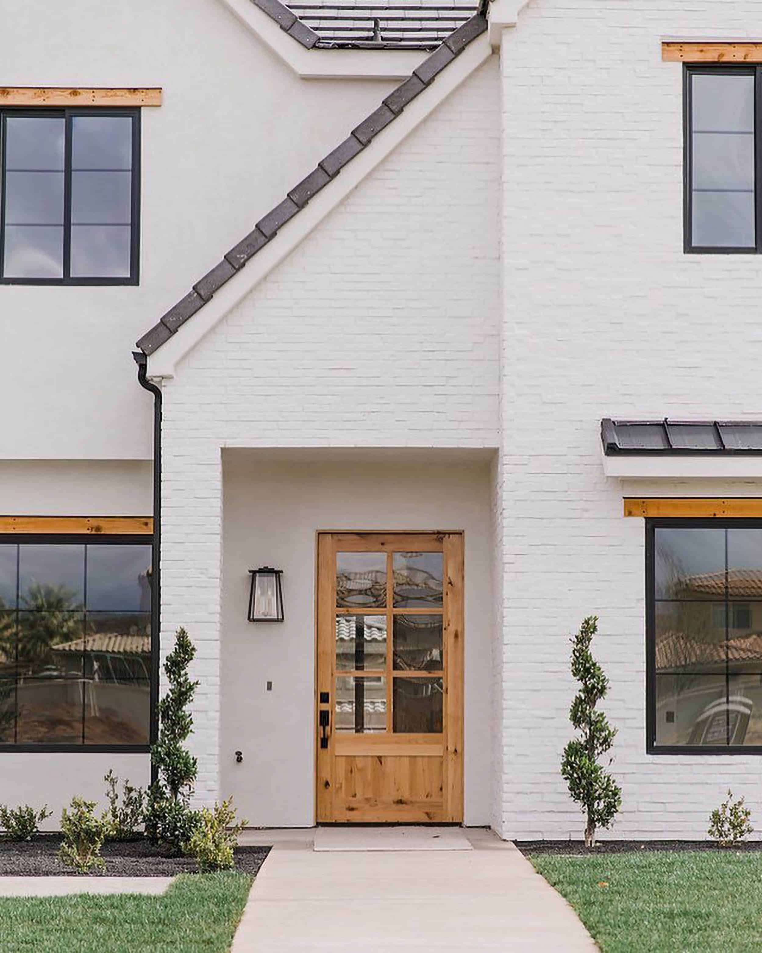 Becki Owens White Brick Home Wood Door