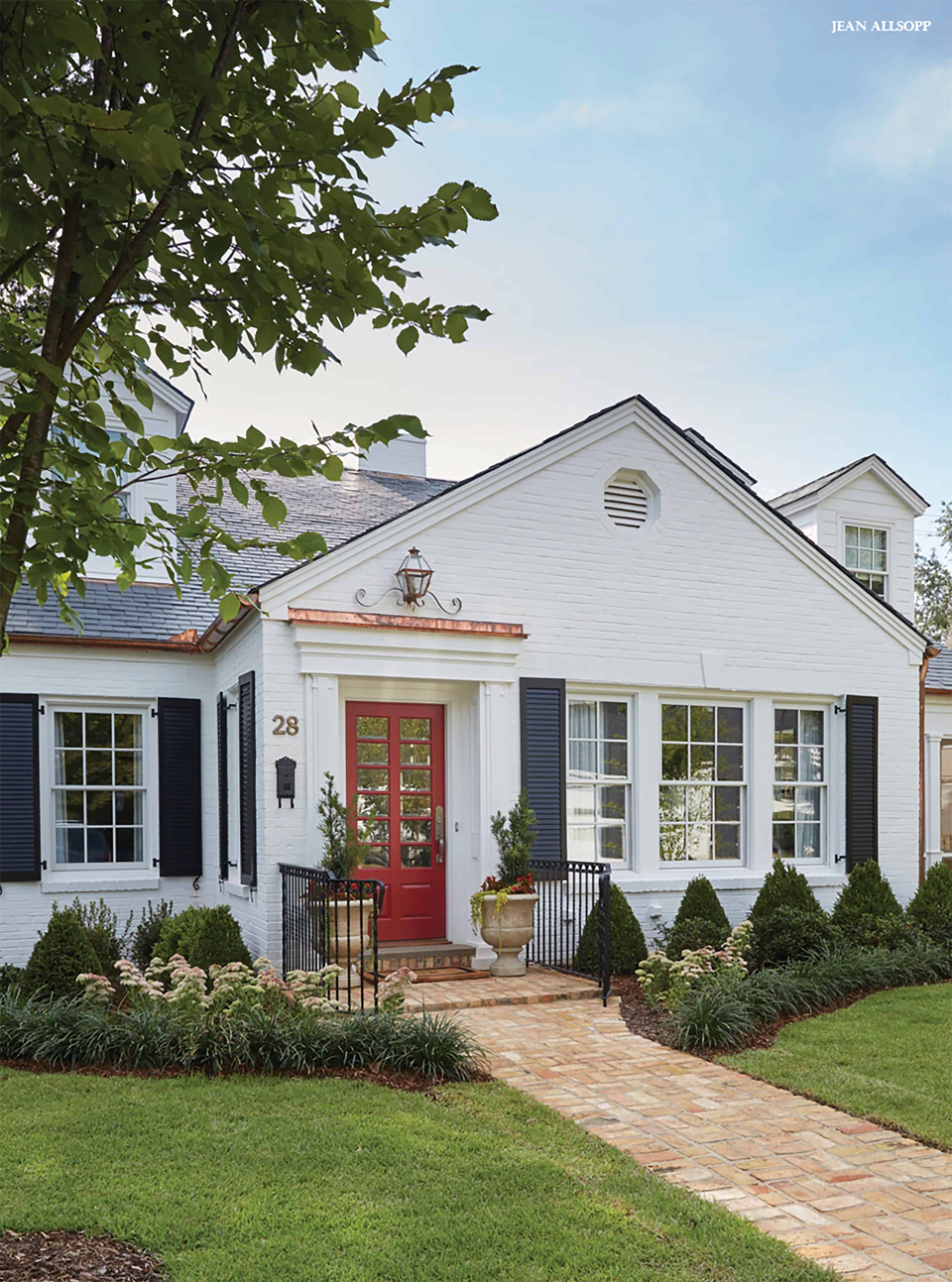 White Home With Black Shutters and Red Door