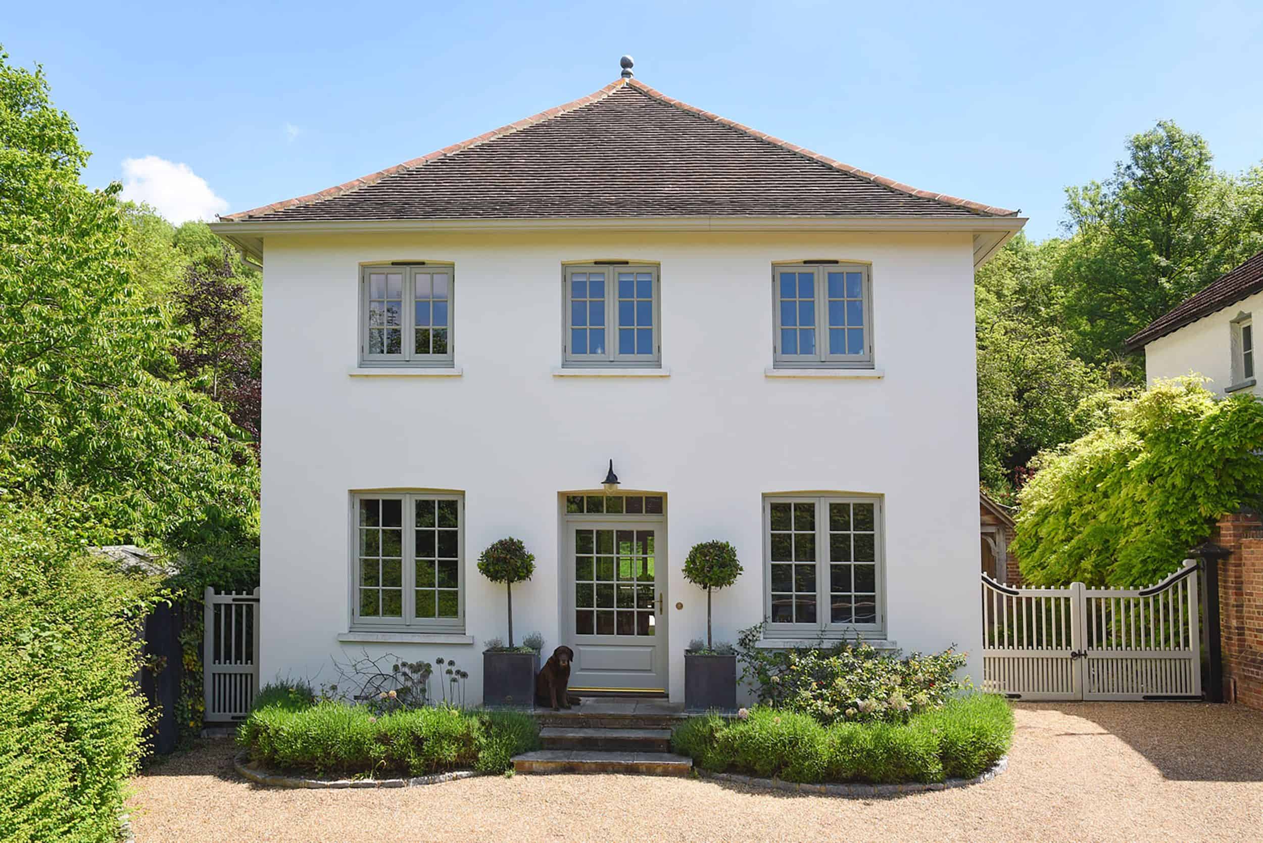 Cream Colored Home With Sage Green Trim and Door