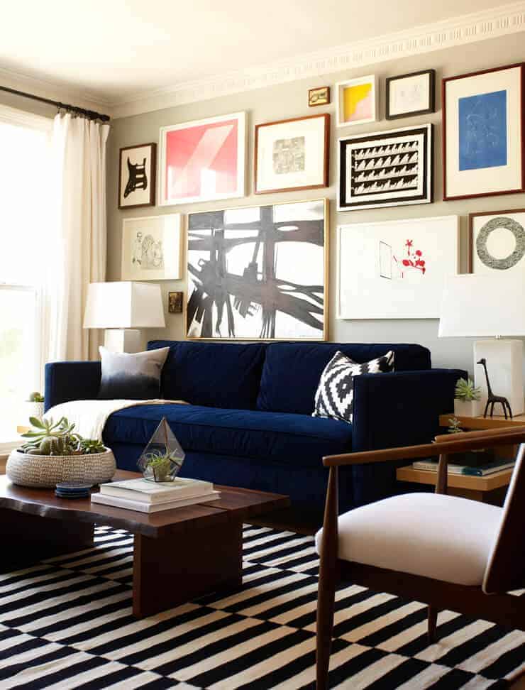 gallery wall above navy sofa